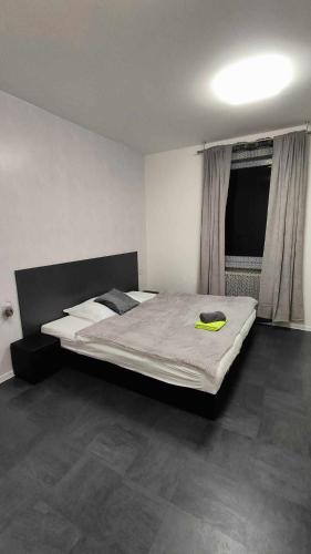 a bedroom with a bed with a yellow blanket on it at Apartmány u golfu in Jihlava