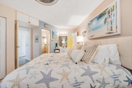a bedroom with a large bed with stars on it at Maui Sunset B402 in Kihei
