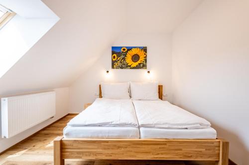a bedroom with a bed with a painting on the wall at Wellness zoo apartmány Lhota in Lomnice nad Lužnicí