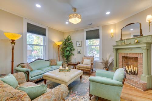a living room with blue couches and a fireplace at Danville Retreat with Hot Tub and Cozy Fireplace! in Danville