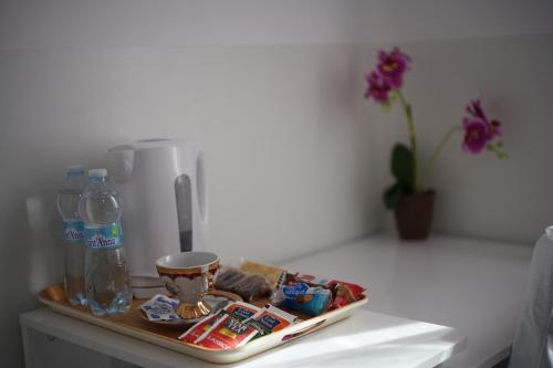 a tray of food and drinks on a table at Welcome Milano Guest House in Milan