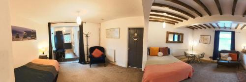 - une chambre avec 2 lits dans une pièce au plafond dans l'établissement King St Cosy - wood stove & ice maker, à Loughborough