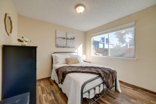 a bedroom with a bed and a window at Sparks Retreat with Private Hot Tub and Cozy Fireplace in Sparks