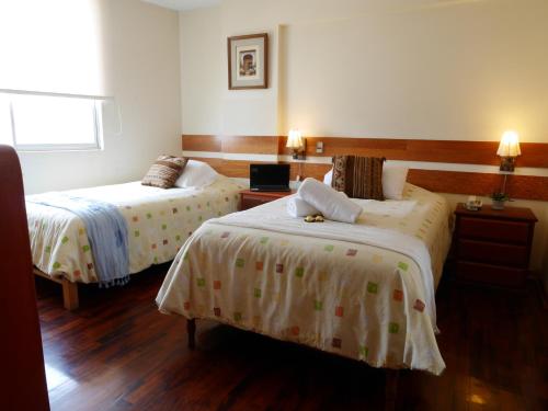 Postel nebo postele na pokoji v ubytování Suite Service Apart Hotel