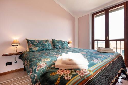 a bedroom with a bed with towels on it at Terrazza Sulla Luna in Casciana Terme
