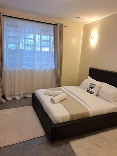 Ένα ή περισσότερα κρεβάτια σε δωμάτιο στο Elysian Homes Nakuru