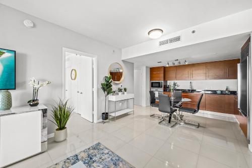 a kitchen and living room with a table and chairs at *ICONIC W ICON CONDO/ POOL&WATERVIEWS*FREESPA* in Miami