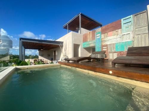 a swimming pool in the backyard of a house at Kataleya Tulum by Zaazil - New Luxury Penthouse Up to 10 people, 3-level, 3240 sqft , Private Pool, Terrace and Roof Top in Luum Zama in the Jungle in Tulum