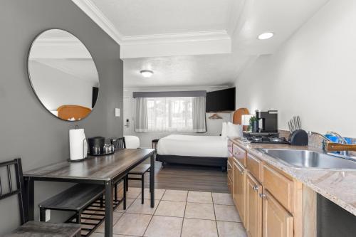 a kitchen with a sink and a room with a bed at Beachcomber Motel in Fort Bragg