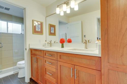 a bathroom with a sink and a toilet and a mirror at Beautiful Seattle Home with Patio about 9 Mi to Downtown in Seattle