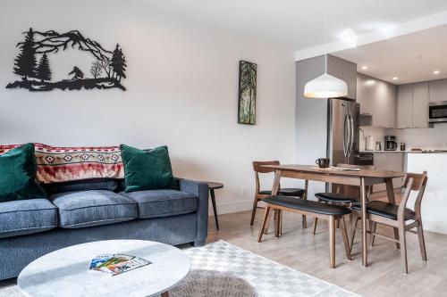 a living room with a couch and a table at Wildflower Retreat by Revelstoke Vacations in Revelstoke
