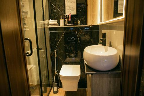 a bathroom with a sink and a toilet at Bogotá by Homefront Encanto in Abuja