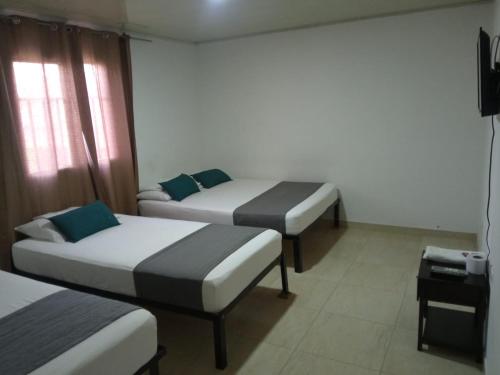 מיטה או מיטות בחדר ב-Hotel Casa Guajira Real