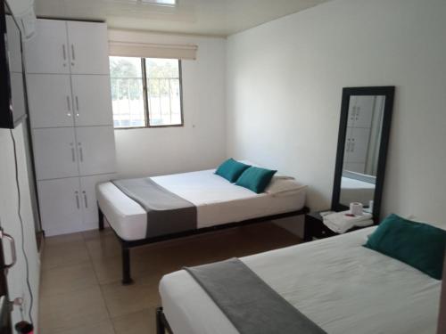 מיטה או מיטות בחדר ב-Hotel Casa Guajira Real