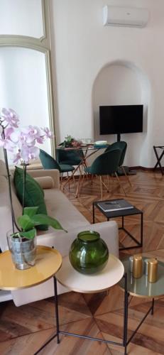 a living room with two tables and a couch at Mercanti e Viaggiatori in Turin