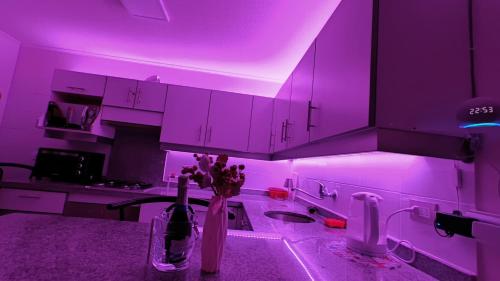a kitchen with purple lighting in a kitchen with a sink at La Serena y Coquimbo -WIFI 300MB - NETFLIX - ALEXA - TV CABLE in Coquimbo