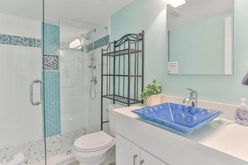 La salle de bains est pourvue d'un lavabo bleu et d'une douche. dans l'établissement Dolphin Point 402C - 2BR Updated Condo with Harbor and Gulf Views, à Destin