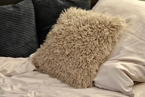 a teddy bear laying on top of a bed at Rocky Studio Chamonix Sud in Chamonix-Mont-Blanc