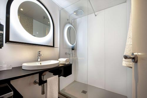 a bathroom with a sink and a mirror at Best Western Porte du Forez in Andrézieux-Bouthéon