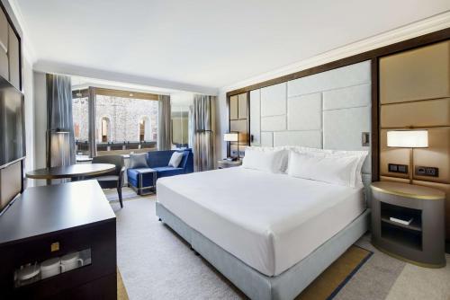 a hotel room with a bed and a desk at Hilton Budapest in Budapest