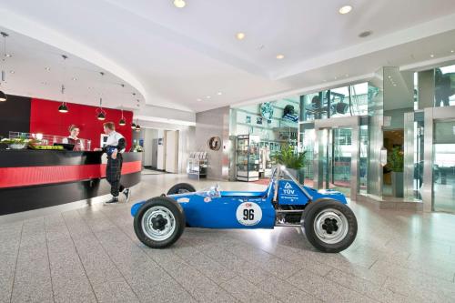 a blue race car parked in a lobby at Dorint Am Nürburgring Hocheifel in Nürburg