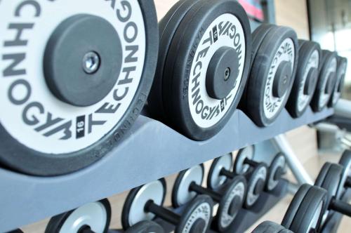 a row of dumbbells in a gym at Country Inn & Suites by Radisson Kota in Kota