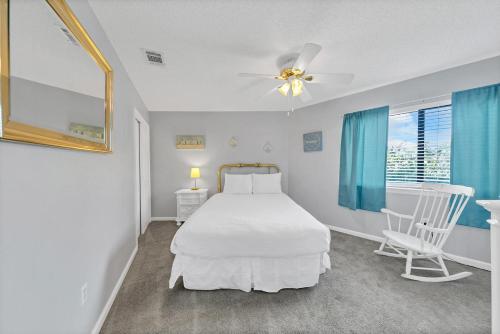 a bedroom with a bed and a chair and a window at Crystal Village II 18A - 2Bedroom 2BA Condo near the Beach Sleeps 6! in Destin