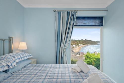 a bedroom with a bed and a view of the ocean at Brynawelon - Wonderful Sea and Harbour Views in Saundersfoot