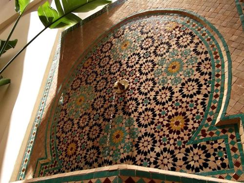 a wall with a mosaic design on a building at RIAD GREEN LOTUS in Marrakech