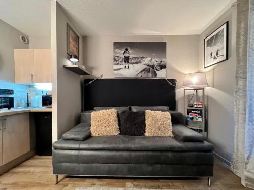 a living room with a couch in a kitchen at Rocky Studio Chamonix Sud in Chamonix-Mont-Blanc