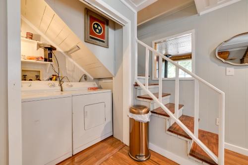 a small kitchen with a sink and a staircase at Pet-Friendly Springville Cabin Near Kentucky Lake! in Durham Subdivision