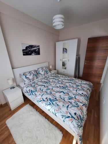 a bedroom with a bed and a white rug at Apartman Bedem in Čačak