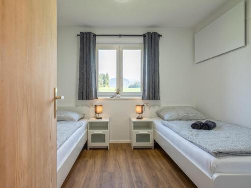 Schwoich的住宿－Chalet Pölven，配有两张床铺的房间,配有两盏灯
