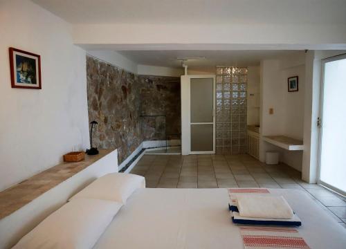 um quarto com uma cama grande e um chuveiro em Casas del Acantilado - Acapulco em Acapulco