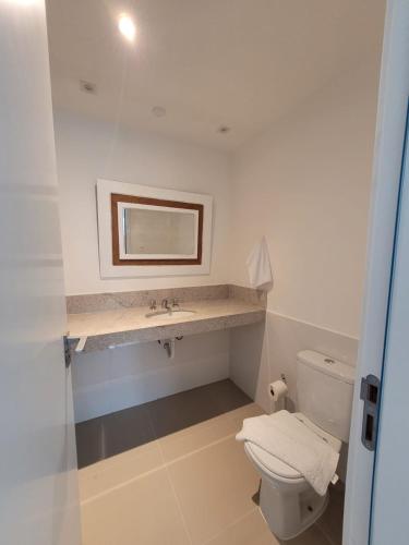 a bathroom with a white toilet and a sink at Casa Villa Constanza in Itaipava