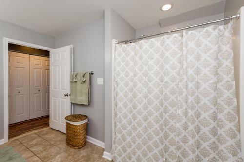 a bathroom with a shower with a shower curtain at Patty Posh Palace in Annapolis