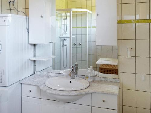 a white bathroom with a sink and a mirror at 6 person holiday home in EIDSVÅG-By Traum in Rød