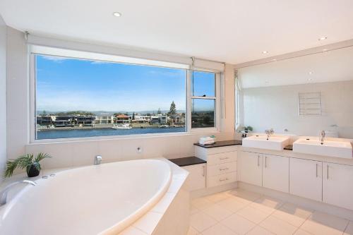 a large bathroom with two sinks and a large tub at A Perfect Stay - Casa Grande On The Water in Gold Coast