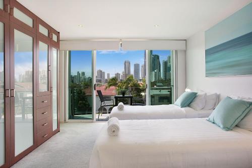 a bedroom with two beds and a view of the city at A Perfect Stay - Casa Grande On The Water in Gold Coast