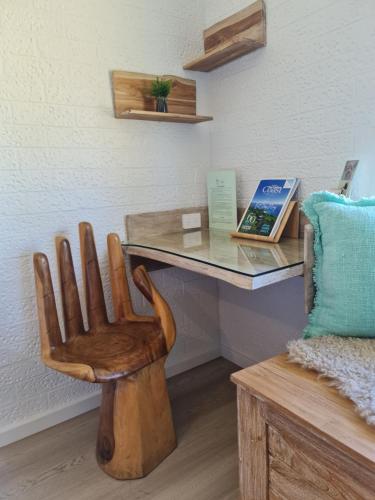 a wooden chair sitting in front of a desk at Vacy Hunter Valley Lodge in Vacy