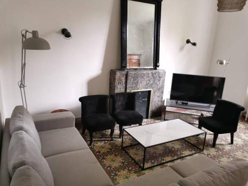un salon avec un canapé et une cheminée dans l'établissement Magnifique maison années 30 proche des remparts, à Avignon