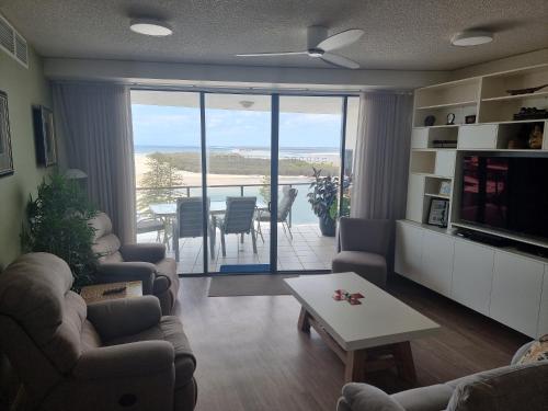 a living room with a view of the ocean at The Waterford Prestige Apartments in Caloundra