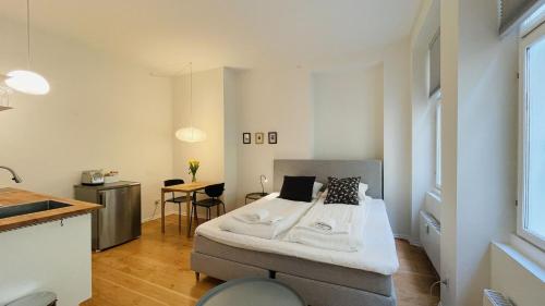 a small bedroom with a bed and a kitchen at ApartmentInCopenhagen Apartment 1539 in Copenhagen