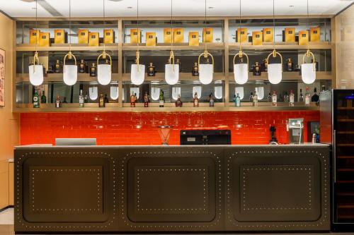 a bar with a counter with a bunch of bottles at Rezen Select Hotel guagnzhou Baiyun International Airport T2 Canton Fair Shuttle in Huadu