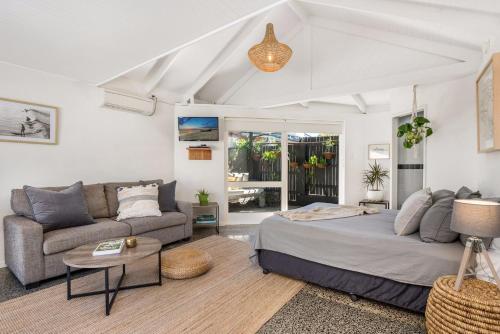 a living room with a bed and a couch at A Perfect Stay - 3 Little Pigs in Byron Bay