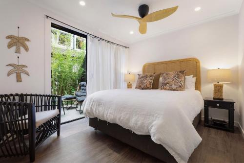 a bedroom with a large bed and a balcony at A Perfect Stay - A Top Spot in Byron Bay