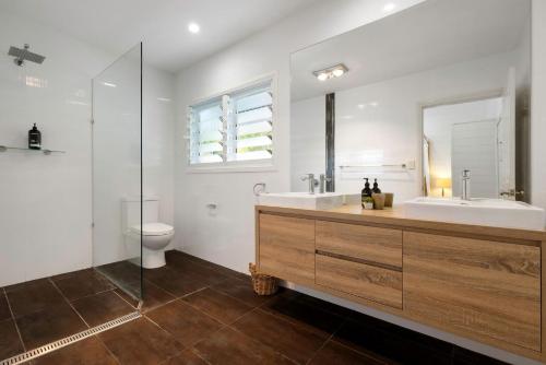 a bathroom with a sink and a tub and a toilet at A Perfect Stay Aaloka Bay in Byron Bay