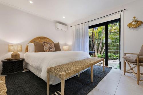 a bedroom with a bed and a sliding glass door at A Perfect Stay - Arya in Byron Bay