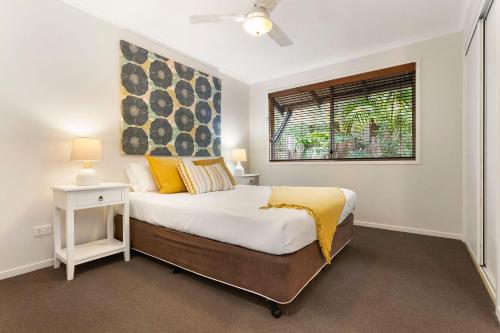 a bedroom with a large bed and a window at A Perfect Stay - Beach House at Tallows in Byron Bay