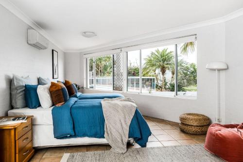a bedroom with a bed and a large window at A Perfect Stay - Byron Pacific Vista in Byron Bay